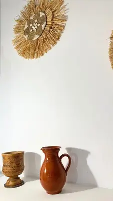 two vases sitting on a table next to a wall at Peters Studio in Archangelos