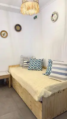 a bedroom with a wooden bed with pillows on it at Peters Studio in Archangelos