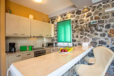 a kitchen with a counter with a bowl of fruit on it at Villa Helios in Kalathos