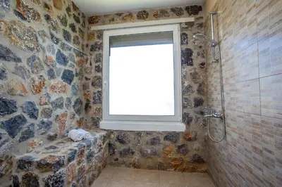 a bathroom with a window and a shower at Villa Helios in Kalathos