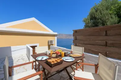 a table with a basket of food on a patio at Astradeni House by Blue Wave in Symi