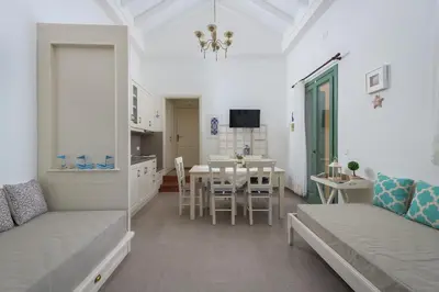 a living room with a table and a dining room at Astradeni House by Blue Wave in Symi