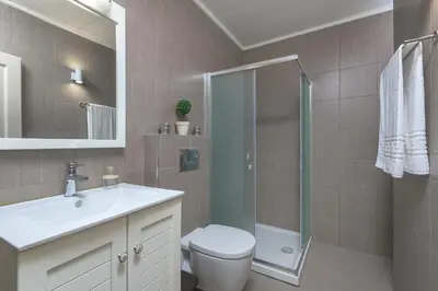 a bathroom with a toilet and a sink and a shower at Astradeni House by Blue Wave in Symi
