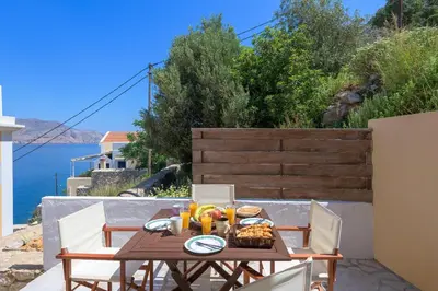 a table with food on it on a patio at Astradeni House by Blue Wave in Symi