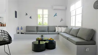 a living room with a couch and a table at 30villa Rd in Rhodes Town