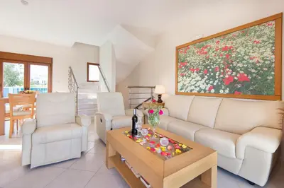 a living room with a couch and a table at Horizon Line Villas in Kiotari