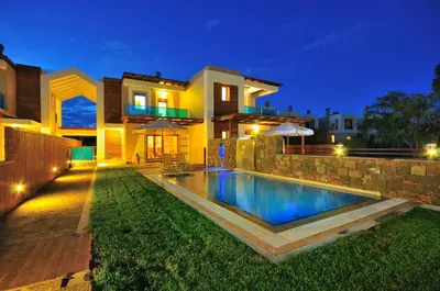 a house with a swimming pool at night at Horizon Line Villas in Kiotari