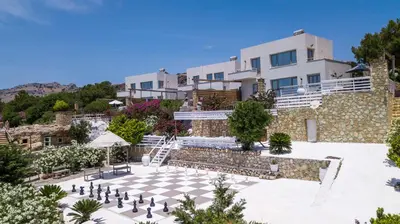 an image of a villa with a chessboard in front of a building at Spilia Bay Villas in Pefki Rhodes
