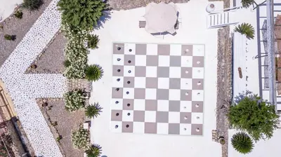an overhead view of a chessboard in a courtyard at Spilia Bay Villas in Pefki Rhodes