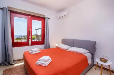 a bedroom with a bed with towels on it at Spilia Bay Villas in Pefki Rhodes