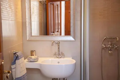 a bathroom with a sink and a mirror and a shower at Villa Lindos in Líndos