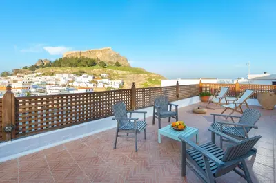 a balcony with chairs and a table with a view at Villa Lindos in Líndos
