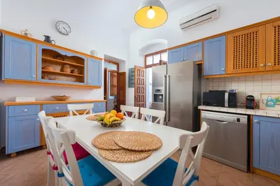 a kitchen with a table with a bowl of fruit on it at Villa Lindos in Líndos