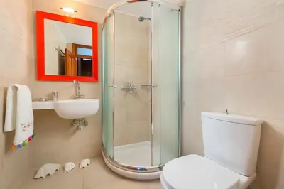 a bathroom with a shower and a toilet and a sink at Villa Lindos in Líndos