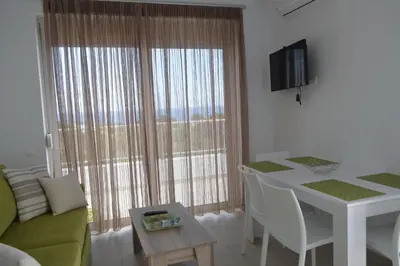 a living room with a couch and a table at Gennadi Gardens exclusive apartments in Gennadi
