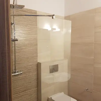 a bathroom with a toilet and a shower at Gennadi Gardens exclusive apartments in Gennadi