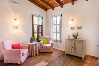 a living room with two chairs and a table at Sunny Countryside Villa - With private pool in Faliraki