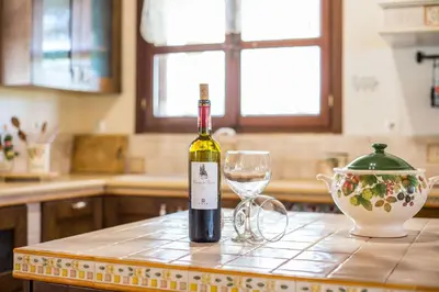 a bottle of wine and a glass on a kitchen counter at Sunny Countryside Villa - With private pool in Faliraki
