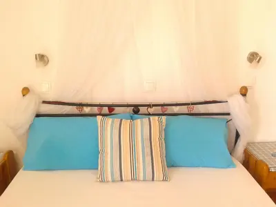 a bed with two pillows on top of it at Vivian Studios in Ialyssos
