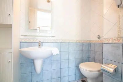 a bathroom with a sink and a toilet at Villa Galanis in Symi