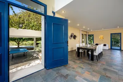 an open door to a dining room with a table at Themis Private Villa Rhodes in Ialyssos