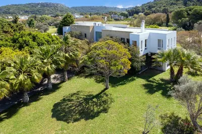 an aerial view of a white house with palm trees at Themis Private Villa Rhodes in Ialyssos