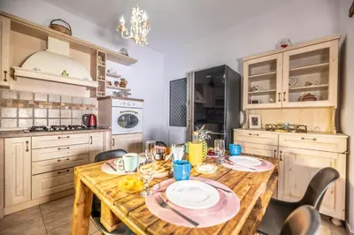a kitchen with a wooden table with plates on it at Ktima Argyrou Stegna in Archangelos