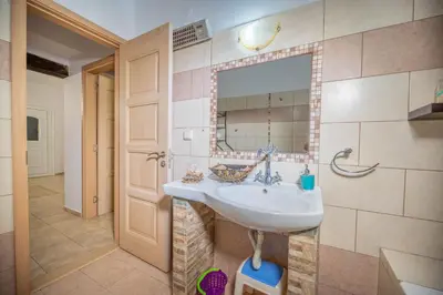 a bathroom with a sink and a mirror at Ktima Argyrou Stegna in Archangelos