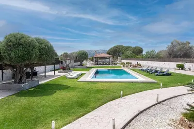 a backyard with a swimming pool and a gazebo at Marble Pool Villa in Pastida