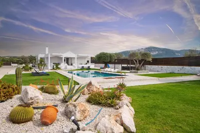 a house with a swimming pool in a yard at Marble Pool Villa in Pastida