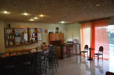 a kitchen with a bar and some stools in a room at Kremasti Memories in Kremasti