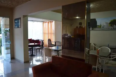 a living room with a table and a dining room at Kremasti Memories in Kremasti