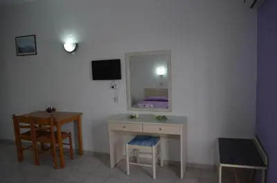 a room with a vanity with a mirror and a table at Kremasti Memories in Kremasti