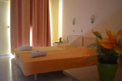 a bedroom with two beds with towels on them at Kremasti Memories in Kremasti