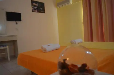 a hotel room with two beds and a glass bowl at Kremasti Memories in Kremasti