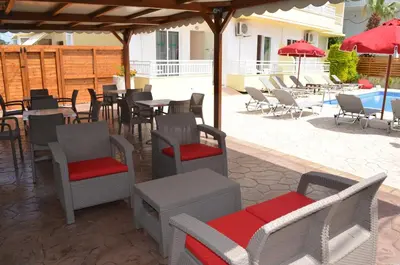 a patio with chairs and tables and umbrellas at Kremasti Memories in Kremasti
