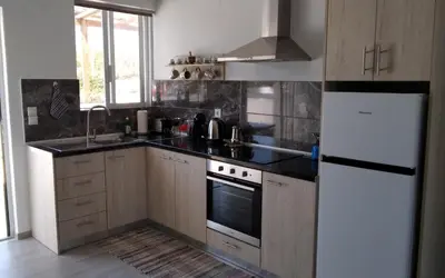 a kitchen with wooden cabinets and a white refrigerator at Endless BLUE Lahania in Lachania