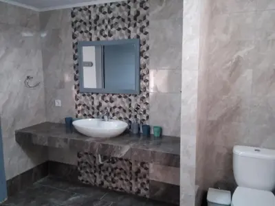 a bathroom with a sink and a mirror and a toilet at Endless BLUE Lahania in Lachania