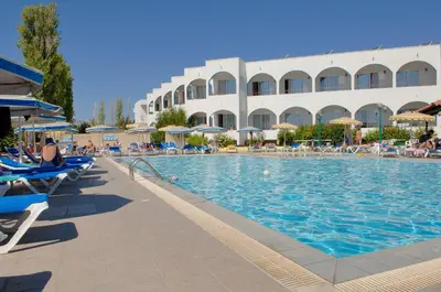 a swimming pool at a resort with chairs and umbrellas at Kolymbia Sun in Kolimbia