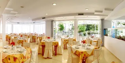 a banquet hall with tables and chairs in a room at Kolymbia Sun in Kolimbia