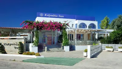 a building with pink flowers on the front of it at Kolymbia Sun in Kolimbia
