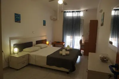 a bedroom with a bed with two towels on it at Nicholas Waves Beach Studios in Lardos