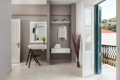 a bathroom with a sink and a mirror at Maravelia's Rooms in Symi