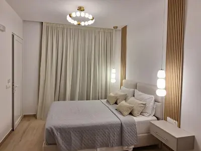 a bedroom with a bed and a chandelier at George Beach Studios in Pefki Rhodes