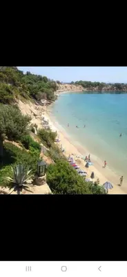a view of a beach with people in the water at George Beach Studios in Pefki Rhodes