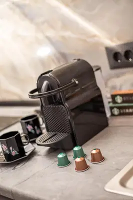 a kitchen counter with a coffee maker on a counter at Jimmy’s Garden in Faliraki