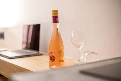 a bottle of champagne sitting next to a wine glass at Jimmy’s Garden in Faliraki