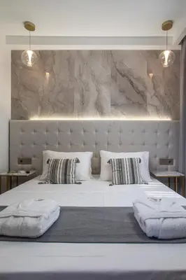a large white bed with two pillows on it at Jimmy’s Garden in Faliraki