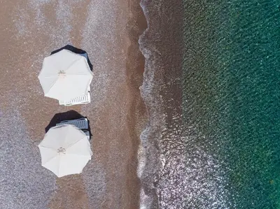 an overhead view of two umbrellas on the beach at Haraki Sea View Luxury House in Rhodes Town