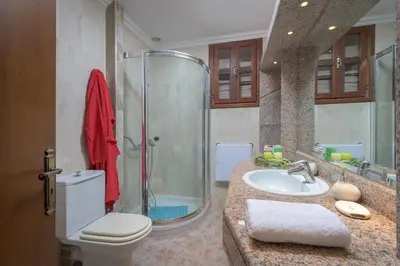 a bathroom with a toilet and a sink and a shower at Haraki Sea View Luxury House in Rhodes Town